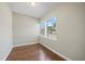 Simple bedroom featuring vinyl hardwood floors, a window and neutral tones at 4804 N 18Th St, Tampa, FL 33610