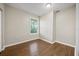 Simple bedroom featuring vinyl hardwood floors, a window and neutral tones at 4804 N 18Th St, Tampa, FL 33610
