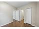 A bedroom features wood-look floors, neutral walls, and white doors to closets and other rooms at 4804 N 18Th St, Tampa, FL 33610