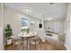 Bright dining area with a modern table and chairs, and views into the living room at 4804 N 18Th St, Tampa, FL 33610