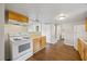 Functional kitchen featuring wooden cabinets and modern white appliances at 4804 N 18Th St, Tampa, FL 33610