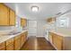 Bright kitchen featuring wooden cabinets, white appliances, and hardwood floors at 4804 N 18Th St, Tampa, FL 33610