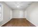 An empty living room boasts hardwood floors and a ceiling fan at 4804 N 18Th St, Tampa, FL 33610