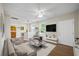 Spacious living room with hardwood floors, a ceiling fan, and views into the kitchen at 4804 N 18Th St, Tampa, FL 33610