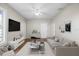 Bright living room featuring a modern sofa, stylish decor, and a ceiling fan at 4804 N 18Th St, Tampa, FL 33610