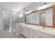 Modern bathroom featuring a double vanity, large mirror, and glass-enclosed shower at 503 W Warren Ave # 1, Tampa, FL 33624