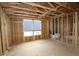 Unfinished bedroom with a window view; shows the framing, walls, and floor, ready for customization at 503 W Warren Ave # 1, Tampa, FL 33624