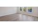 Bright bedroom with three windows, hardwood floors, and neutral walls at 503 W Warren Ave # 1, Tampa, FL 33624
