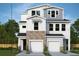 New two-story home with white siding, stone accents, and a two-car garage at 503 W Warren Ave # 1, Tampa, FL 33624