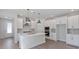 Modern kitchen with white cabinets, stainless steel appliances, and an island with a white countertop at 503 W Warren Ave # 1, Tampa, FL 33624