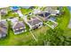 Expansive aerial view showcasing a pristine home with lush green lawns in a well-maintained neighborhood at 5057 Ivory Stone Dr, Wimauma, FL 33598