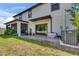 A well-kept backyard featuring a screened porch, sliding glass door and patio area at 5057 Ivory Stone Dr, Wimauma, FL 33598