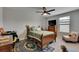 Bedroom with a ceiling fan, carpet and a large window at 5057 Ivory Stone Dr, Wimauma, FL 33598