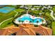 Aerial view of a resort-style community pool and recreational area, showcasing the community's amenities at 5057 Ivory Stone Dr, Wimauma, FL 33598