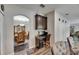 A view of the dining area showing an arched entrance and wood-look floors at 5057 Ivory Stone Dr, Wimauma, FL 33598
