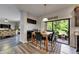 A dining area with a wooden table and chairs is adjacent to the backyard patio at 5057 Ivory Stone Dr, Wimauma, FL 33598
