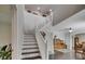 Bright entryway with staircase, dark hardwood floors and an open concept design at 5057 Ivory Stone Dr, Wimauma, FL 33598