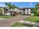 Beautiful two-story home featuring a well-manicured lawn and mature palm trees at 5057 Ivory Stone Dr, Wimauma, FL 33598