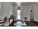 Elegant foyer featuring dark hardwood floors and a decorative glass front door at 5057 Ivory Stone Dr, Wimauma, FL 33598