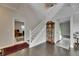 A spacious foyer features a staircase, wood-look floors, and an antique grandfather clock at 5057 Ivory Stone Dr, Wimauma, FL 33598