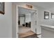 Hallway displaying an open door and wall decor at 5057 Ivory Stone Dr, Wimauma, FL 33598