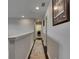 Hallway with dark laminate flooring and neutral colored walls and trim at 5057 Ivory Stone Dr, Wimauma, FL 33598