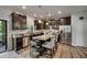 The kitchen features dark cabinets, stainless appliances, and a granite island with seating at 5057 Ivory Stone Dr, Wimauma, FL 33598