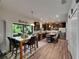 Spacious kitchen with stainless appliances, an island, and a large sliding glass door at 5057 Ivory Stone Dr, Wimauma, FL 33598