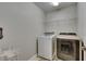 Laundry room with updated washer and dryer machines with storage above at 5057 Ivory Stone Dr, Wimauma, FL 33598