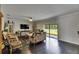 The living room features dark wood floors and sliding glass doors leading to the backyard at 5057 Ivory Stone Dr, Wimauma, FL 33598