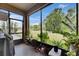 View of the screened patio that showcases the lush green backyard and white picket fence at 5057 Ivory Stone Dr, Wimauma, FL 33598