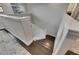 Well-lit staircase featuring white railings and stylish hardwood steps at 5057 Ivory Stone Dr, Wimauma, FL 33598