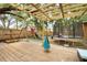 Backyard features a wooden deck with pergola, swingset, and a trampoline for outdoor fun and entertainment at 5149 4Th St, Zephyrhills, FL 33542