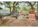 Large backyard with mature trees offers a playground, trampoline, and plenty of space for outdoor activities at 5149 4Th St, Zephyrhills, FL 33542