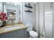 Bathroom with granite vanity offers a serene space with natural light and a neutral color scheme at 5149 4Th St, Zephyrhills, FL 33542