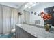 Bathroom features a spacious vanity with granite countertop, modern fixtures, and neutral color palette at 5149 4Th St, Zephyrhills, FL 33542