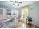Bright bedroom offers built-in bunk beds, wood flooring, and a dedicated desk area for studying and creativity at 5149 4Th St, Zephyrhills, FL 33542