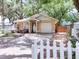 Charming single-story home with a well-manicured lawn, front patio, and attached garage offers curb appeal at 5149 4Th St, Zephyrhills, FL 33542