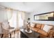 Bright living room featuring a cozy leather sofa, large window and hardwood floors at 5149 4Th St, Zephyrhills, FL 33542