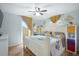Main bedroom with wood flooring, ceiling fan, and access to the outdoors offers a comfortable retreat at 5149 4Th St, Zephyrhills, FL 33542