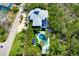 Lovely aerial view of a charming home with swimming pool, lush landscaping, and lots of privacy at 540 Gulf Bay Rd, Longboat Key, FL 34228