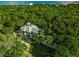 Stunning aerial view of the property showcasing lush landscaping, pool, and architectural details at 540 Gulf Bay Rd, Longboat Key, FL 34228