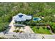 Aerial view of a stunning home with a pool, lush landscaping, and ample privacy at 540 Gulf Bay Rd, Longboat Key, FL 34228