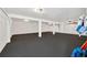 Spacious basement with white walls, black flooring, and ample storage space at 540 Gulf Bay Rd, Longboat Key, FL 34228