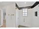 An elegant bathroom featuring a large shower with a window and bronze hardware accents at 540 Gulf Bay Rd, Longboat Key, FL 34228