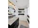 Bathroom features black and white horizontal striped walls, modern vanity, and luxury fixtures at 540 Gulf Bay Rd, Longboat Key, FL 34228