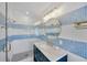 Modern bath features tiled walls, glass-enclosed shower, and marble vanity, perfect for comfort and relaxation at 540 Gulf Bay Rd, Longboat Key, FL 34228