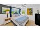 Cozy bedroom features a queen bed, coastal decor, and ample natural light streaming in from the window at 540 Gulf Bay Rd, Longboat Key, FL 34228
