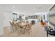 Open-concept dining room with large table, seating for eight, and bright lighting at 540 Gulf Bay Rd, Longboat Key, FL 34228