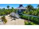 Charming home featuring a cozy porch, lush landscaping, and an inviting exterior design at 540 Gulf Bay Rd, Longboat Key, FL 34228